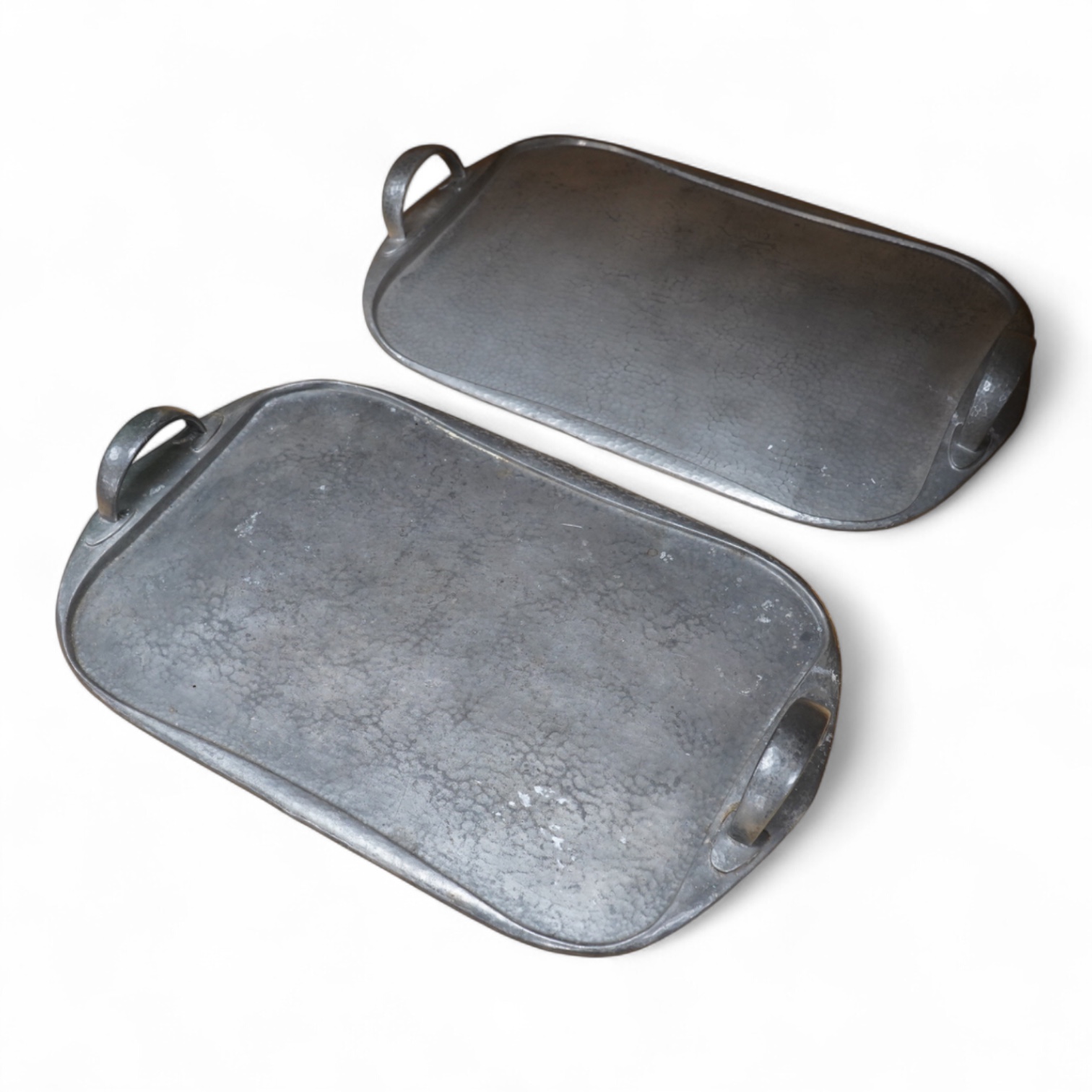Archibald Knox for Liberty, two pewter Arts and Crafts Tudric trays, each numbered 043, 46cm wide